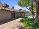 Spacious backyard featuring a sparkling pool, covered patio, lush grass, and mature trees at 6436 Vinecrest Ave, Las Vegas, NV 89108