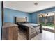 Bedroom with a substantial wood bed, wood dresser, and sliding glass doors at 6436 Vinecrest Ave, Las Vegas, NV 89108
