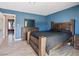 Comfortable bedroom featuring laminate floors, a sizable bed, and a matching dresser with a mirror at 6436 Vinecrest Ave, Las Vegas, NV 89108