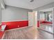 Bedroom with laminate flooring, red accent wall, large closet, and a window at 6436 Vinecrest Ave, Las Vegas, NV 89108