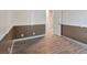 Bedroom with neutral walls, wood-look floors, and an open door to an adjacent room at 6436 Vinecrest Ave, Las Vegas, NV 89108
