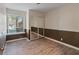 Bedroom with neutral walls, wood-look floors, large window, and closet with sliding mirrored doors at 6436 Vinecrest Ave, Las Vegas, NV 89108