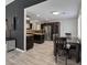Open dining and kitchen area with dark cabinets, stainless steel appliances, and new floors at 6436 Vinecrest Ave, Las Vegas, NV 89108