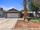 Charming single-story home featuring a well-manicured lawn, desert landscaping, and a two-car garage at 6436 Vinecrest Ave, Las Vegas, NV 89108