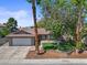 Charming single-story home featuring a well-manicured lawn, desert landscaping, and a two-car garage at 6436 Vinecrest Ave, Las Vegas, NV 89108
