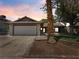 Charming single-story home featuring a well-manicured lawn, desert landscaping, and a two-car garage at 6436 Vinecrest Ave, Las Vegas, NV 89108