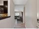 Hallway view looking into living space, with wood-look floors and neutral color palette at 6436 Vinecrest Ave, Las Vegas, NV 89108