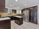 Spacious kitchen with stainless steel appliances, dark cabinetry and a center island at 6436 Vinecrest Ave, Las Vegas, NV 89108