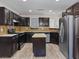 Modern kitchen with stainless steel appliances, dark cabinetry, and a center island at 6436 Vinecrest Ave, Las Vegas, NV 89108