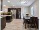 Open kitchen and dining area with wood cabinets, stainless steel appliances and new floors at 6436 Vinecrest Ave, Las Vegas, NV 89108