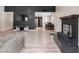 Open living space with a black accent wall, modern fireplace, and adjacent dining area and kitchen at 6436 Vinecrest Ave, Las Vegas, NV 89108