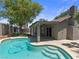 Inviting backyard featuring a sparkling pool, covered patio, and lush landscaping at 6436 Vinecrest Ave, Las Vegas, NV 89108