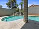 Inviting pool area with lush landscaping and mature palm trees, framed by a decorative stone column at 6436 Vinecrest Ave, Las Vegas, NV 89108