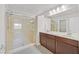 Modern bathroom featuring a double vanity, spacious walk-in shower, and sleek fixtures at 6507 Creekside Cellars Ct, Las Vegas, NV 89139