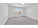Spacious carpeted bedroom with a large window and bright natural light at 6507 Creekside Cellars Ct, Las Vegas, NV 89139