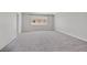 Large, empty bedroom with neutral carpet and a window for natural light at 6507 Creekside Cellars Ct, Las Vegas, NV 89139