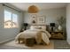 Staged bedroom with a natural aesthetic, featuring neutral decor, soft lighting and a calming atmosphere at 6507 Creekside Cellars Ct, Las Vegas, NV 89139