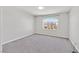 Carpeted bedroom with neutral walls, a window offering neighborhood views, and ample natural light at 6507 Creekside Cellars Ct, Las Vegas, NV 89139