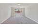 Empty bedroom with neutral carpet, a window offering neighborhood views, and ample natural light at 6507 Creekside Cellars Ct, Las Vegas, NV 89139
