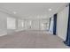 Expansive living room with recessed lighting and large windows, offering abundant natural light and modern appeal at 6507 Creekside Cellars Ct, Las Vegas, NV 89139