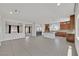 Open concept living space with tile flooring connecting the kitchen and living room area at 6507 Creekside Cellars Ct, Las Vegas, NV 89139