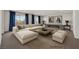 Modern living room with a large sectional sofa, fireplace, and beautiful artwork at 6507 Creekside Cellars Ct, Las Vegas, NV 89139