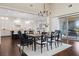 Dining area with hardwood floors and access to the outside dining patio with a grill at 6700 Regency Stone Way, Las Vegas, NV 89148