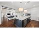 Bright, open kitchen with a large island, stainless steel appliances, and hardwood floors at 6700 Regency Stone Way, Las Vegas, NV 89148