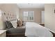 Bright main bedroom with a plush upholstered headboard and plantation shutters at 6700 Regency Stone Way, Las Vegas, NV 89148