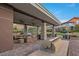 Inviting outdoor kitchen and lounge area featuring stone pillars, comfortable seating, and BBQ grill at 6700 Regency Stone Way, Las Vegas, NV 89148
