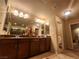 Bright bathroom featuring a double vanity, granite countertops, and a well-lit mirror at 6729 Flamenco Ct, Las Vegas, NV 89139