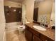 Well-appointed bathroom featuring a bathtub, single vanity with granite countertop and tiled flooring at 6729 Flamenco Ct, Las Vegas, NV 89139