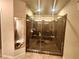 A luxurious, glass-enclosed shower with marble tiling and modern fixtures at 6729 Flamenco Ct, Las Vegas, NV 89139
