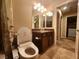 Bathroom features a vanity with granite countertop, toilet, and tiled flooring, complemented by neutral walls and lighting at 6729 Flamenco Ct, Las Vegas, NV 89139