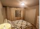 Inviting bedroom features patterned bedding, decorative curtains, closet and soft lighting for a restful atmosphere at 6729 Flamenco Ct, Las Vegas, NV 89139