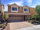 Charming two-story home with a brick-accented front, manicured landscaping, and a paved driveway at 6729 Flamenco Ct, Las Vegas, NV 89139
