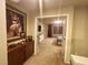 Hallway leading to a bedroom, featuring a cabinet adorned with artwork creating a warm and inviting space at 6729 Flamenco Ct, Las Vegas, NV 89139