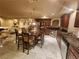 Open-concept kitchen featuring granite countertops, dark wood cabinets, stainless steel appliances, and marble flooring at 6729 Flamenco Ct, Las Vegas, NV 89139