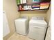 Convenient laundry room equipped with a washer, dryer, and ample storage shelves at 6729 Flamenco Ct, Las Vegas, NV 89139