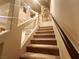 Carpeted staircase with glass railing leading to the upper level of the home at 6729 Flamenco Ct, Las Vegas, NV 89139