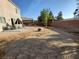 Expansive backyard featuring a patio with outdoor seating and a gravel landscape at 6812 Dipper Ave, North Las Vegas, NV 89084