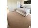 Bedroom with carpet, white bed frame, and natural lighting at 6812 Dipper Ave, North Las Vegas, NV 89084