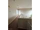 Upstairs hallway with neutral carpet, neutral walls and a door at 6812 Dipper Ave, North Las Vegas, NV 89084