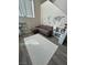 Cozy living area with a comfortable sofa, a world map decal, and light gray vinyl floors at 6812 Dipper Ave, North Las Vegas, NV 89084