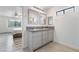 Bright bathroom with dual sink vanity, framed mirrors and tile flooring at 7009 Rawlins Ct, Las Vegas, NV 89128
