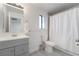 Bathroom features tile floors, single vanity and shower with white shower curtain at 7009 Rawlins Ct, Las Vegas, NV 89128