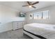Bedroom featuring wood-look floors, ceiling fan, TV and large window at 7009 Rawlins Ct, Las Vegas, NV 89128