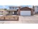 Inviting two-story home featuring a spacious driveway and a well-maintained front yard at 7009 Rawlins Ct, Las Vegas, NV 89128