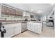 Bright kitchen boasts white cabinets, stainless steel appliances, and modern countertops at 7009 Rawlins Ct, Las Vegas, NV 89128