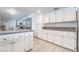 White kitchen with updated cabinets and countertops next to an open living space at 7009 Rawlins Ct, Las Vegas, NV 89128